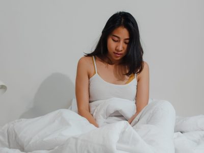 Asian indian lady sleep in room at home. Young Asian girl feeling happy relax rest lying on bed, feel comfortable and calm in bedroom at house at the morning.