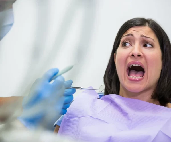 Female patient scared during a dental check-up  in dental clinic