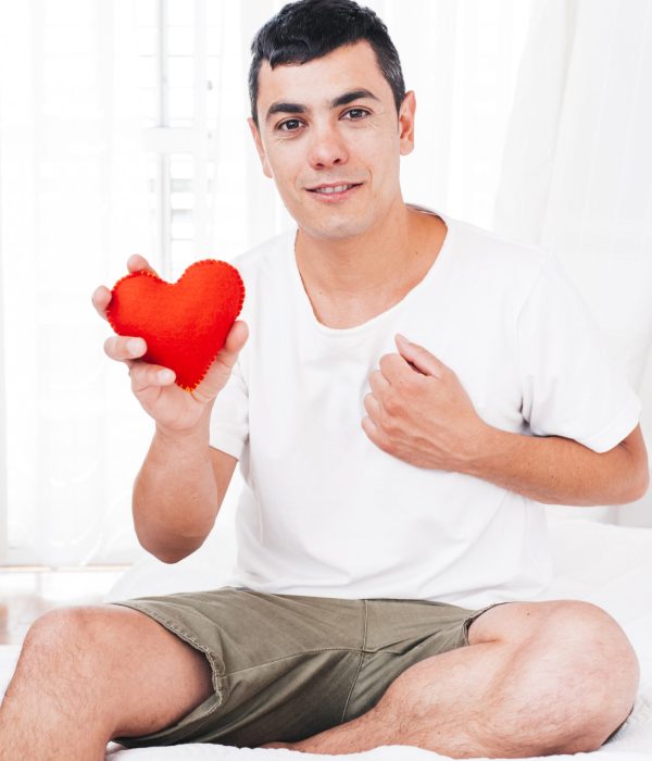 man-with-hand-chest-holding-decorative-heart