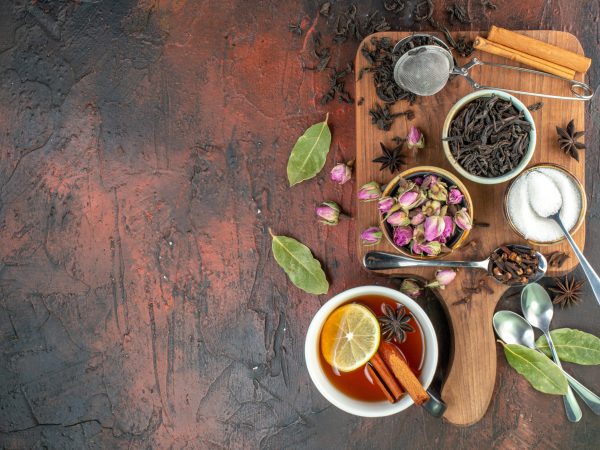 top view cup of tea with black tea and dried flowers on dark brown background tea water color breakfast biscuit photo drink ceremony