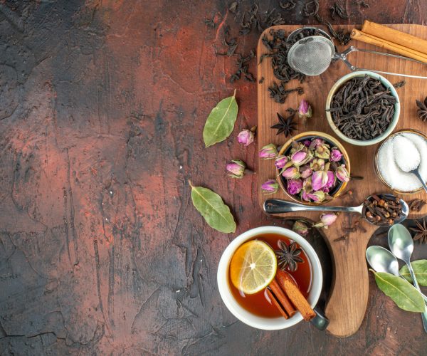 top view cup of tea with black tea and dried flowers on dark brown background tea water color breakfast biscuit photo drink ceremony