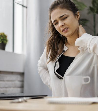 woman-having-neckache-while-working-home