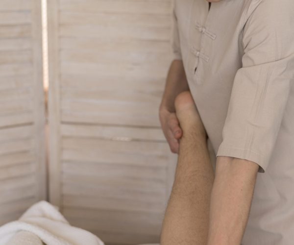 woman-massaging-client-s-leg
