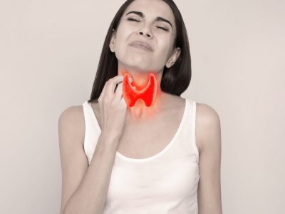 Woman with thyroid gland disease on grey background