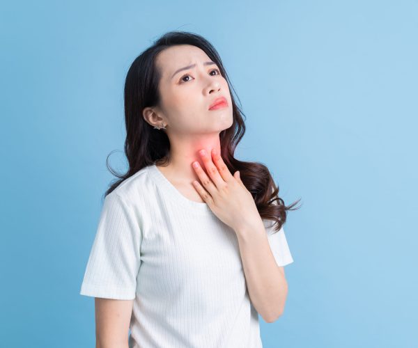 Young Asian woman has a sore throat